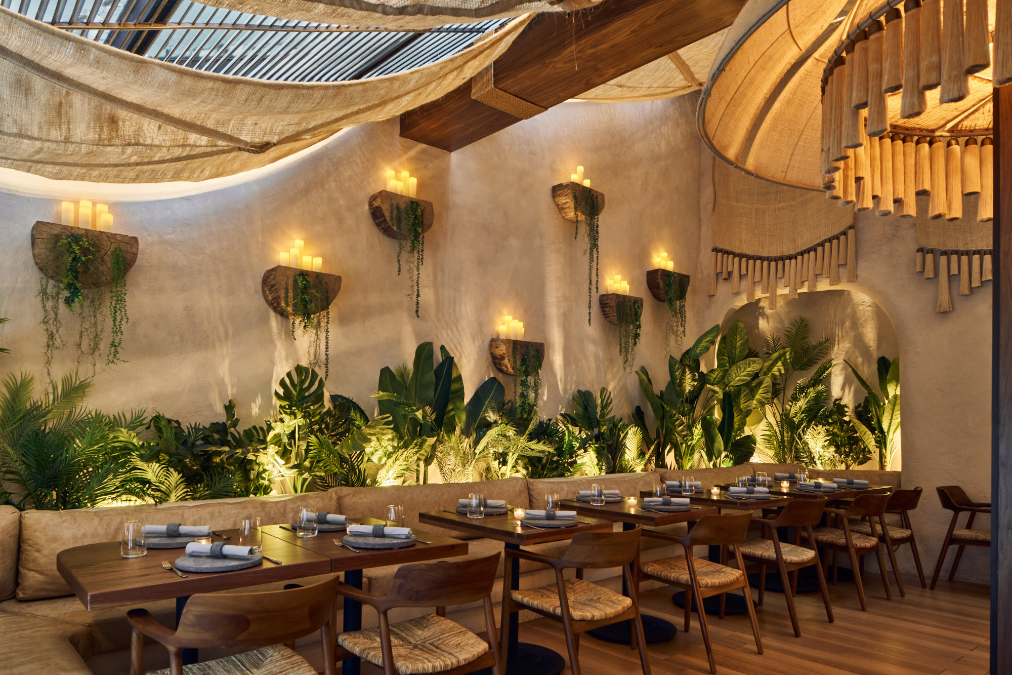 Candlelit booth seating with greenery