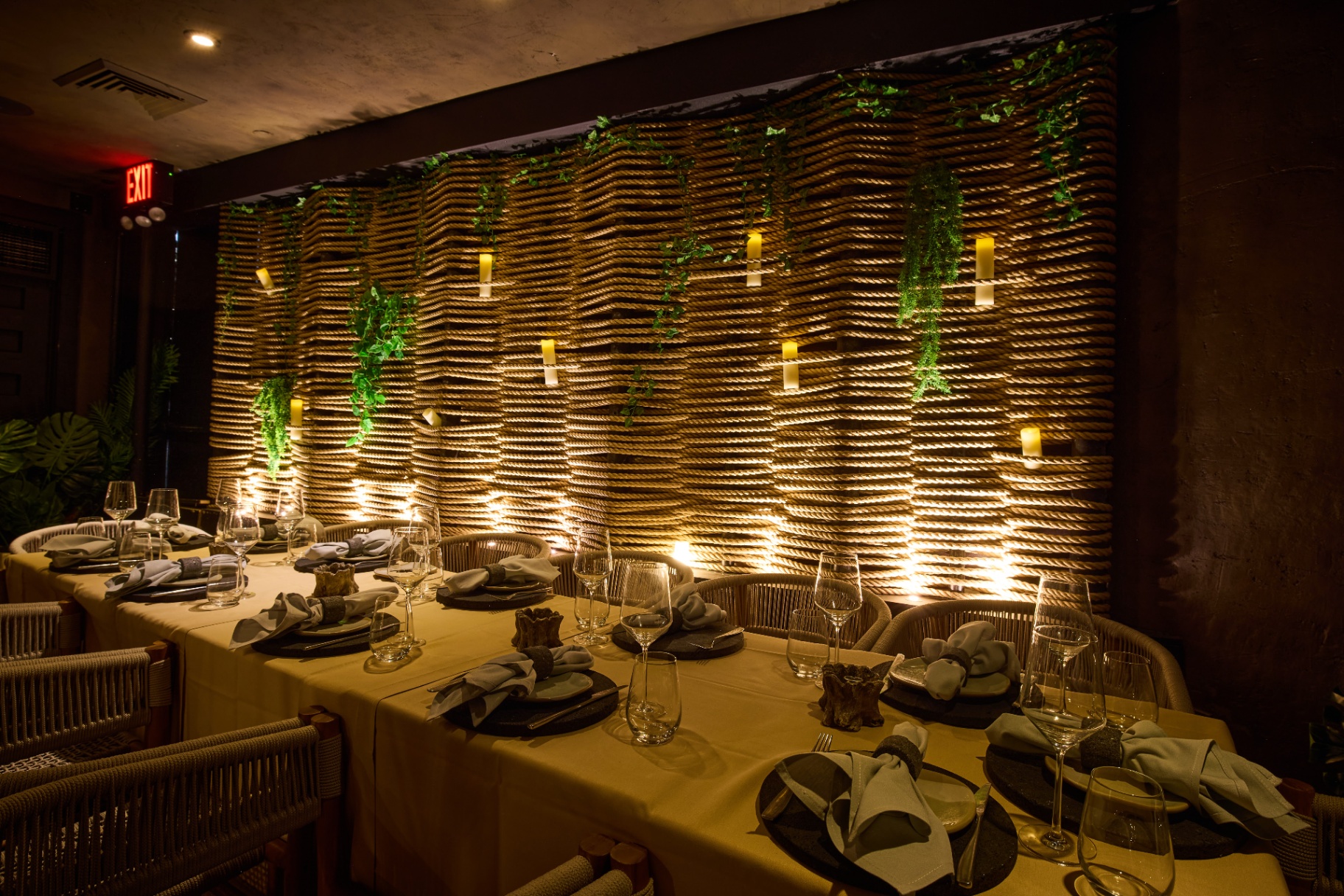 Table setting against an illuminated rope wall